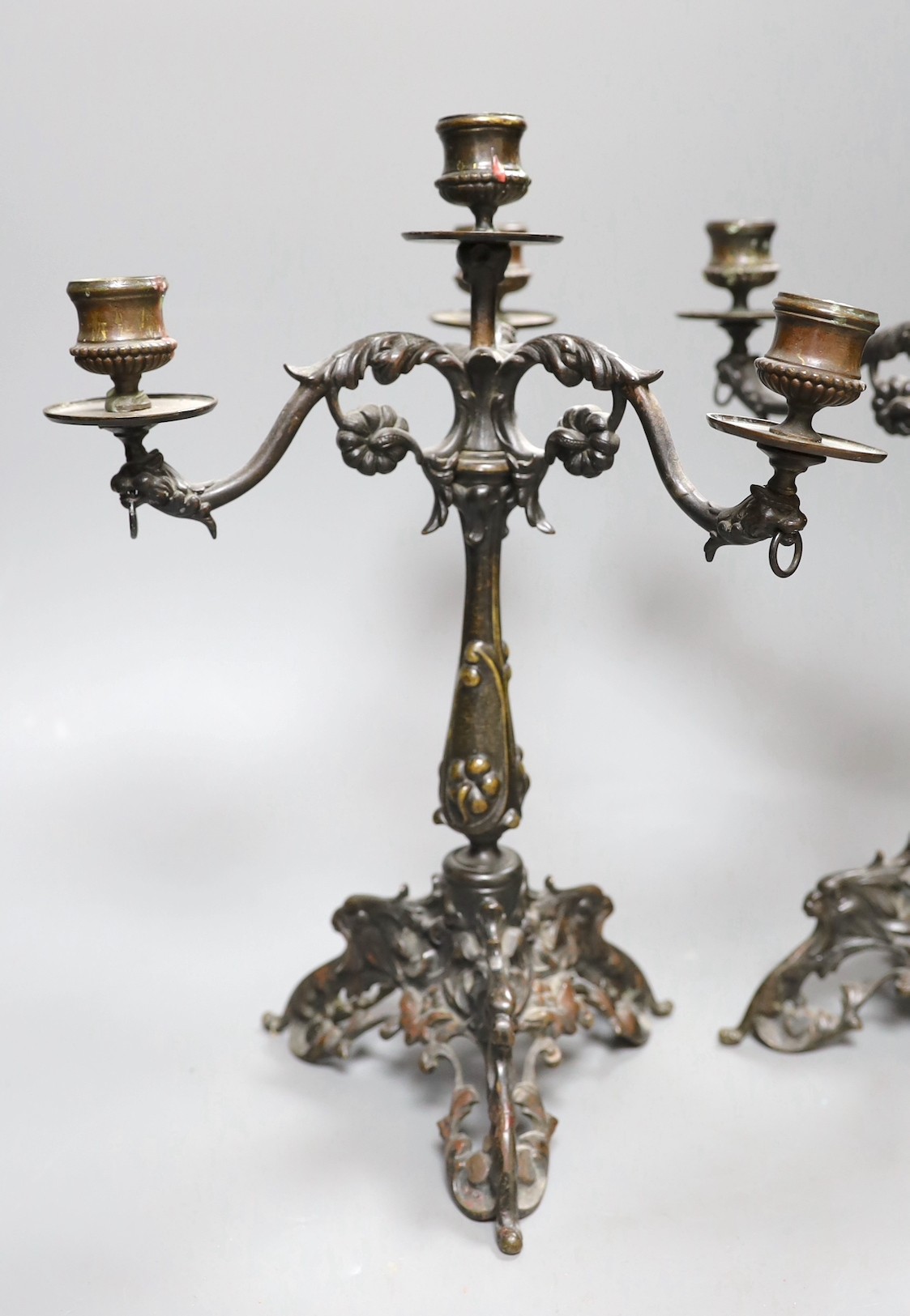 A pair of Victorian style bronze three branch candelabra, 32cm